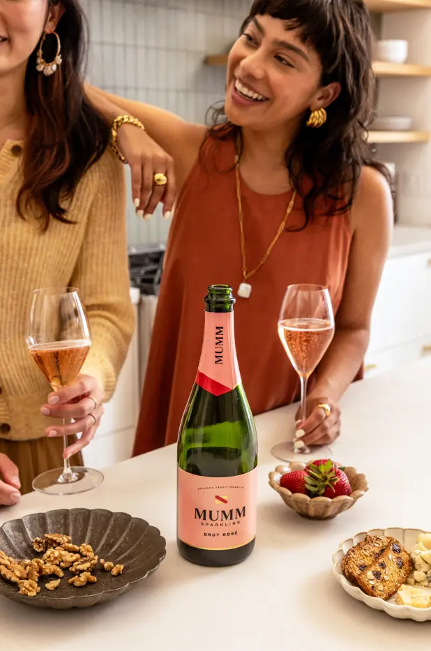 Friends having a drink from Mumm Sparkling Brut Rosé